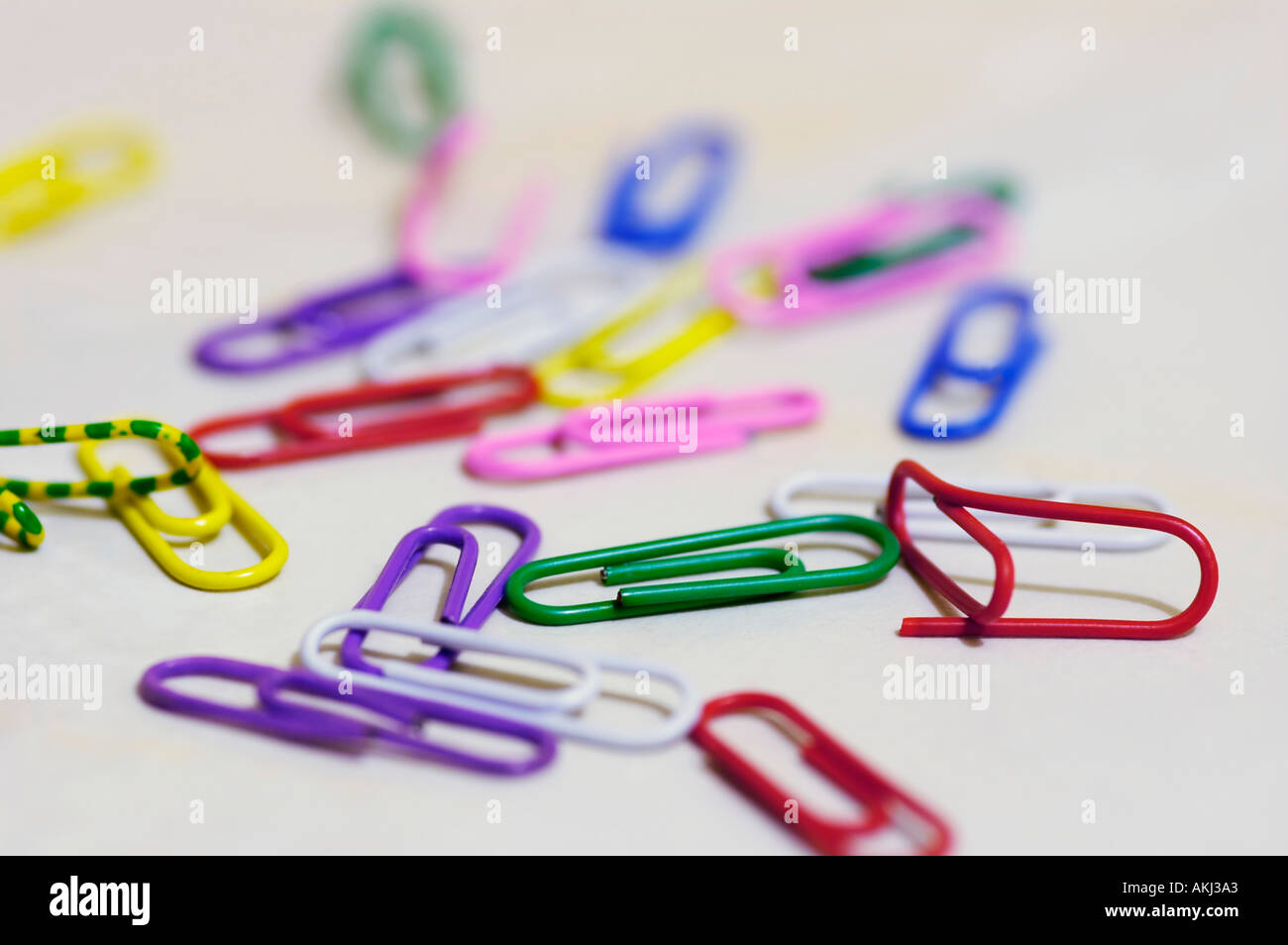 Scattered colour paperclips Stock Photo - Alamy