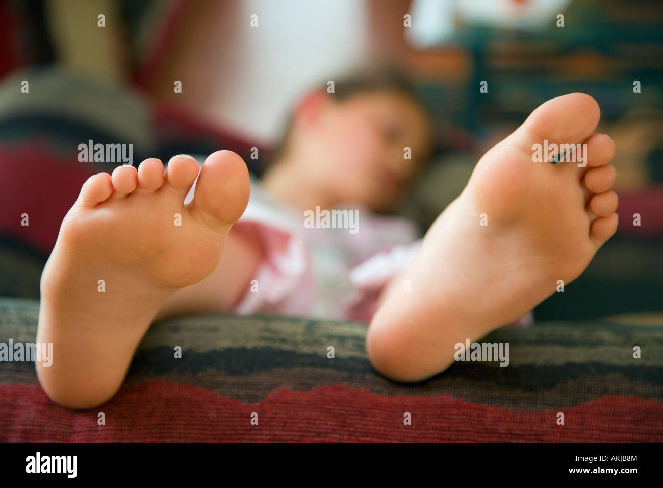 Girl lying on sofa Stock Photo