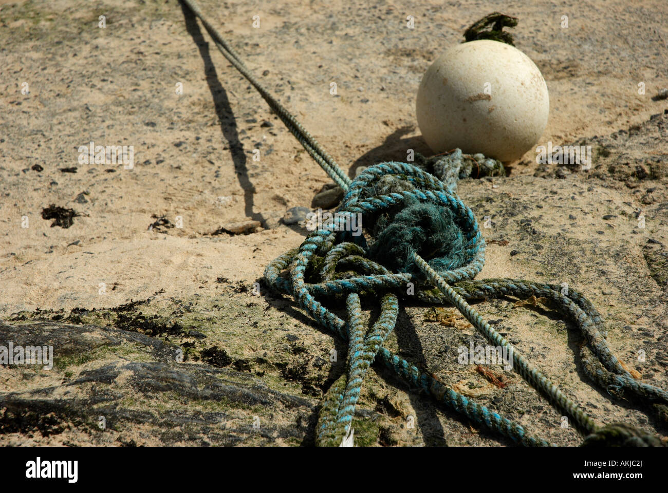 Mooring rope and bouy in the picturesque and pretty fishing village of Mousehole in Cornwall, England,UK Stock Photo