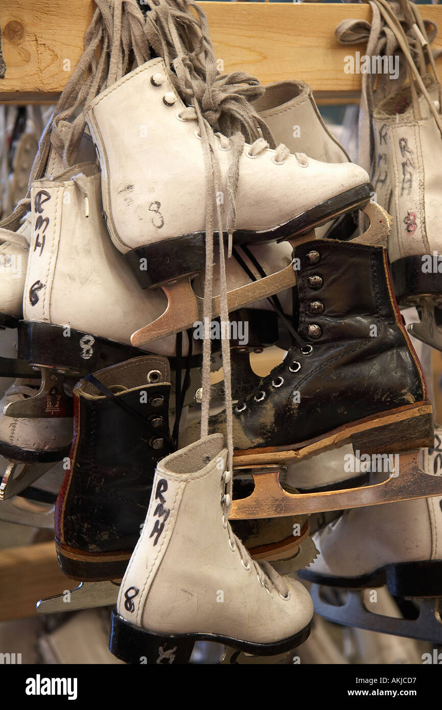 Ice skates hanging on rack at ice skating rink Stock Photo - Alamy