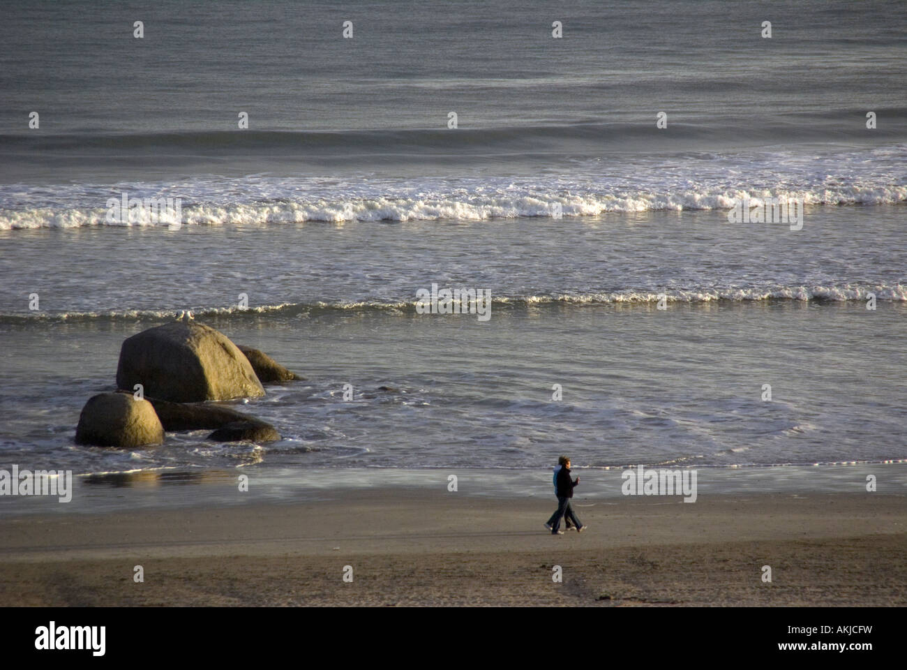Couple walking in morning on beach at South African fishing village of Paternoster on Atlantic coast Stock Photo