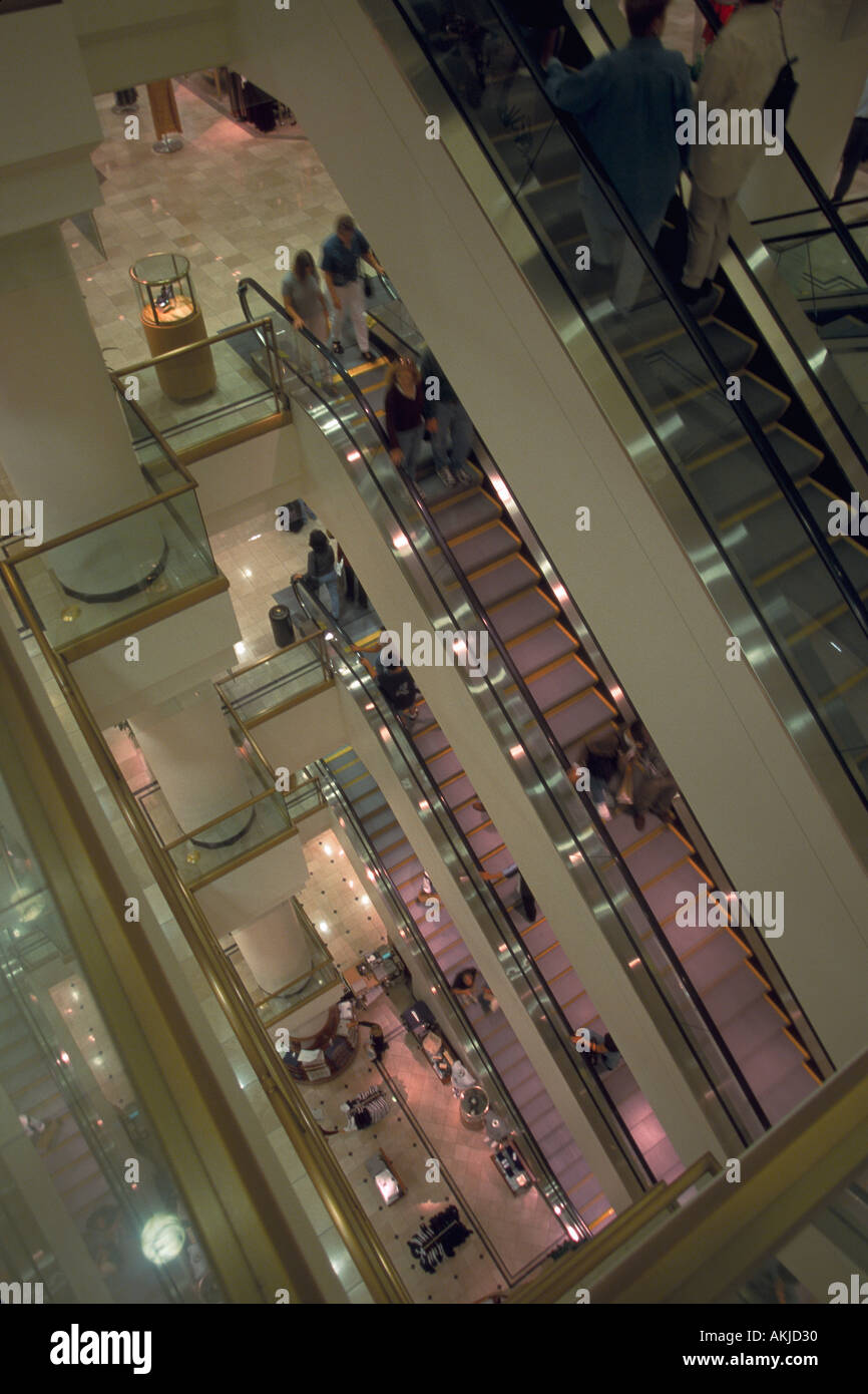 People moving between five different floors on escalators at Nordstrom Clothing Store Seattle WA Stock Photo