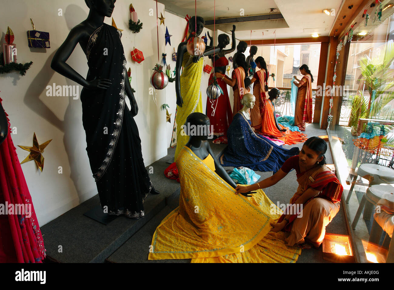 India Window Dresser In A Fabric Shop For Saris Stock Photo