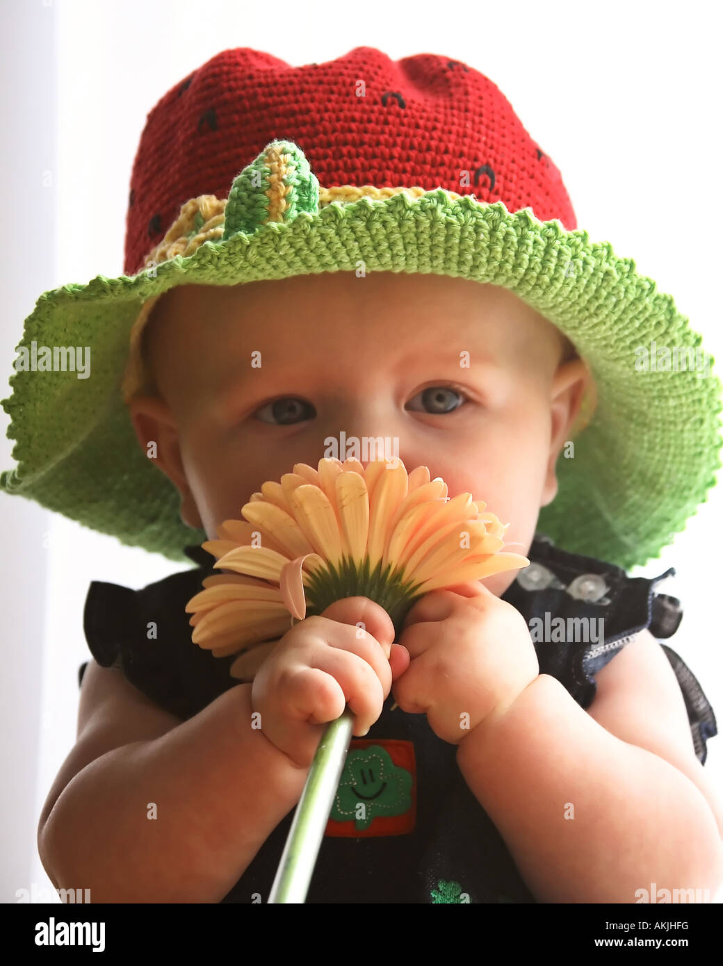 Child smelling flower hi-res stock photography and images - Alamy