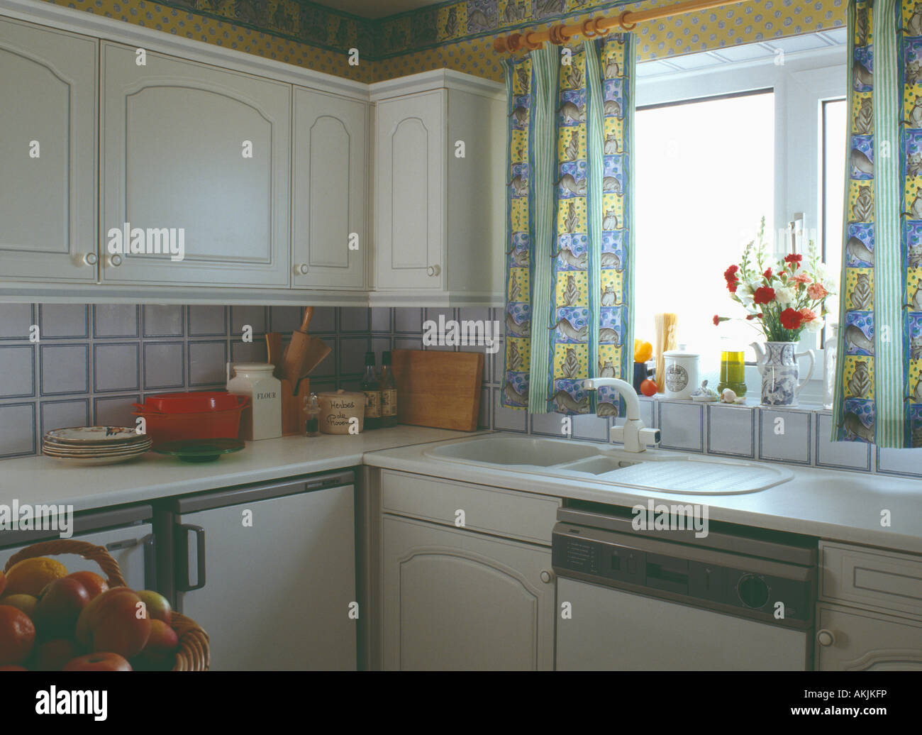 Yellow Patterned Curtains Above White Sink In Small Nineties