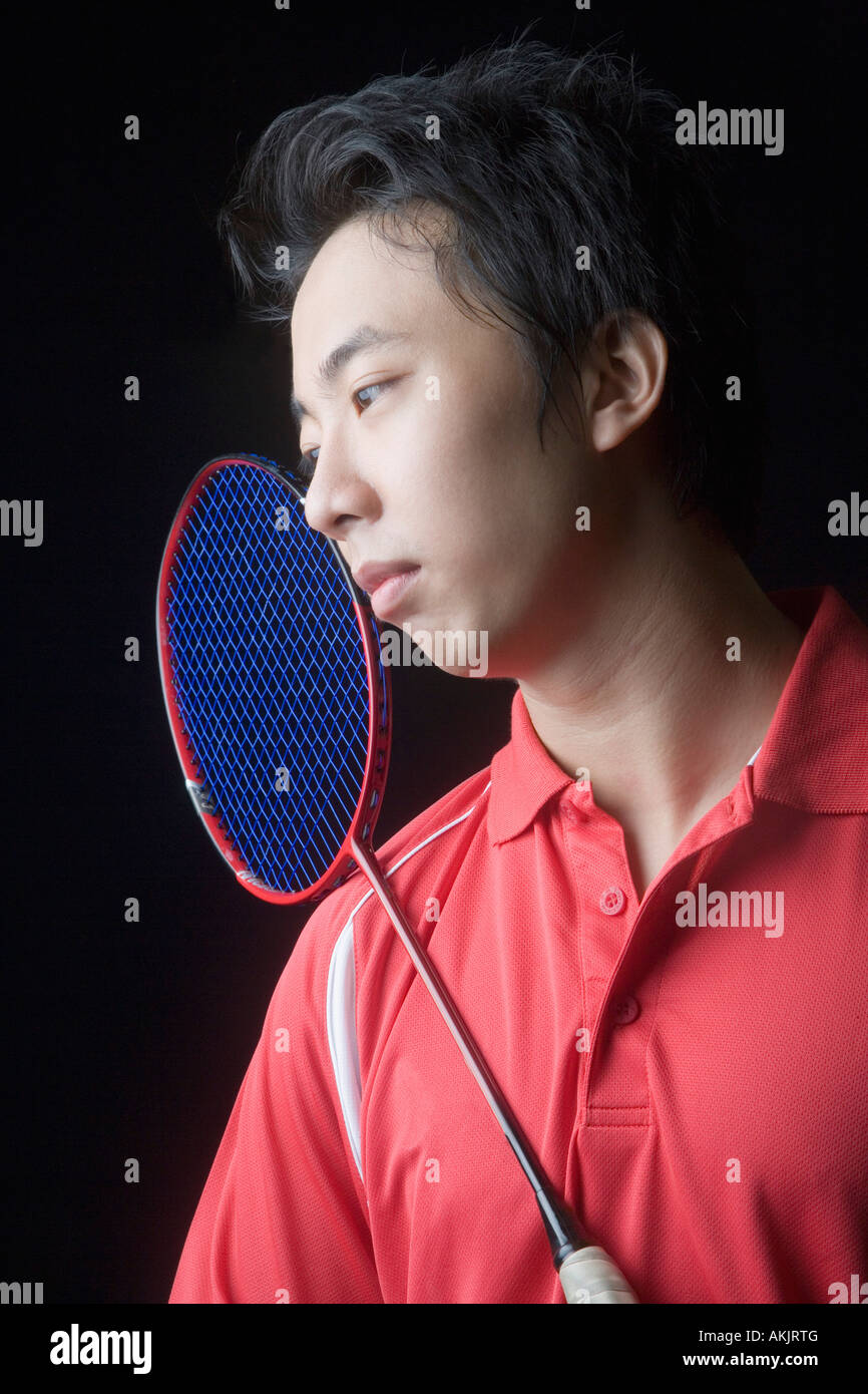 Close-up of a young man with a badminton racket Stock Photo