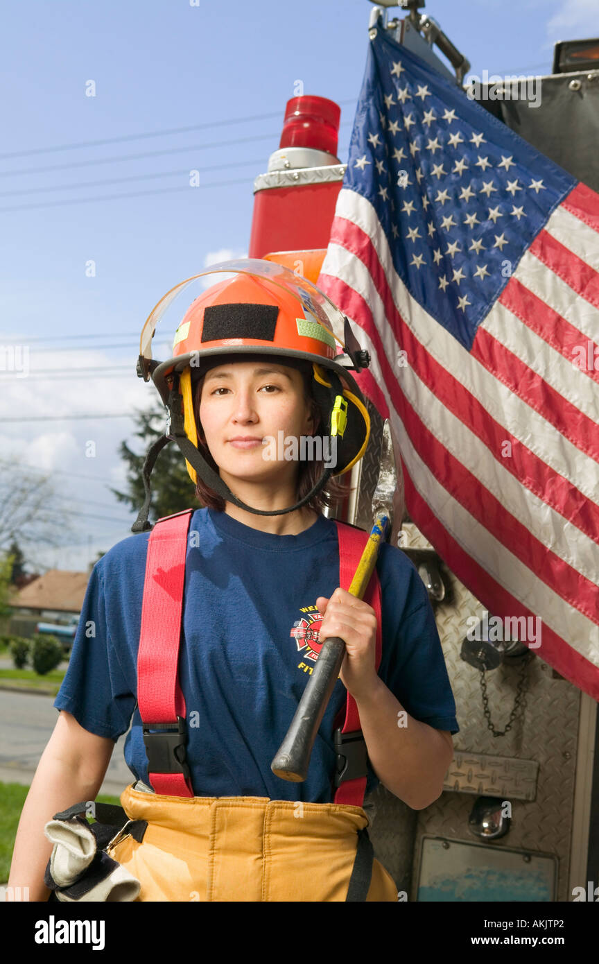 Female firefighter with American flag Stock Photo