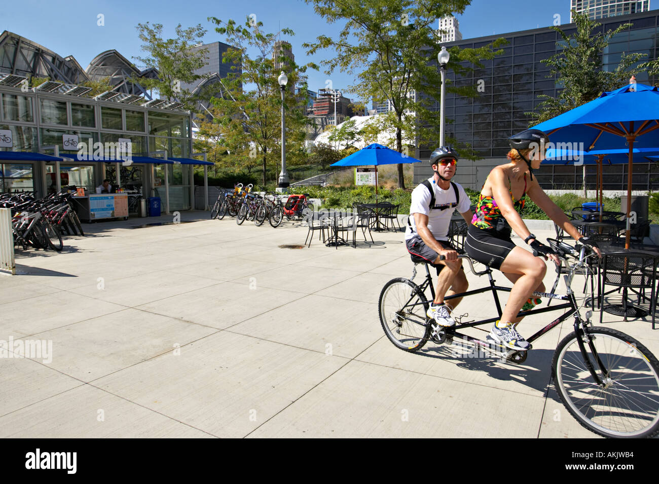 PARKS Chicago Illinois Man and woman ride tandem bicycle leaving Millennium Park bicycle station