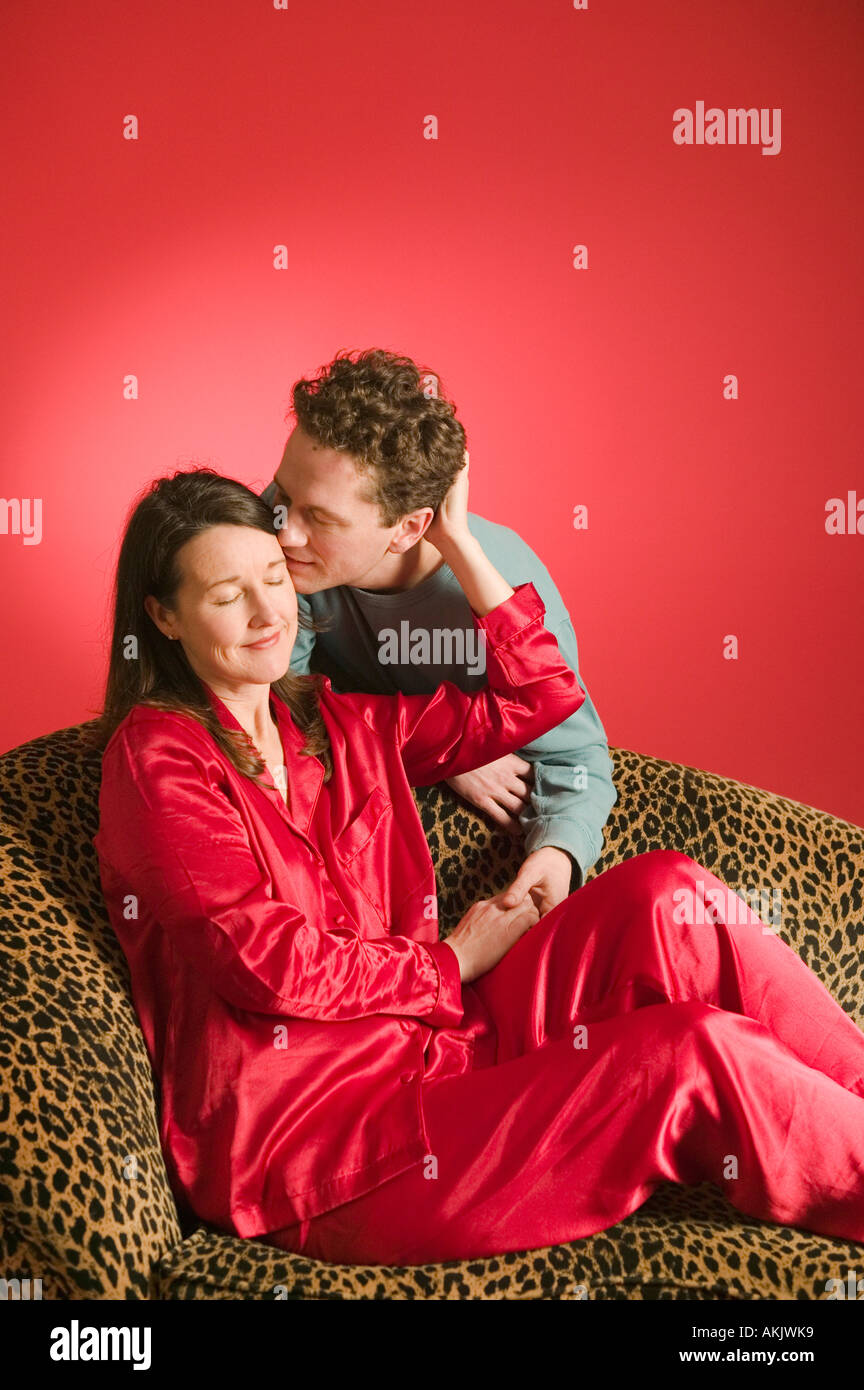 Affectionate couple on leopard print couch Stock Photo