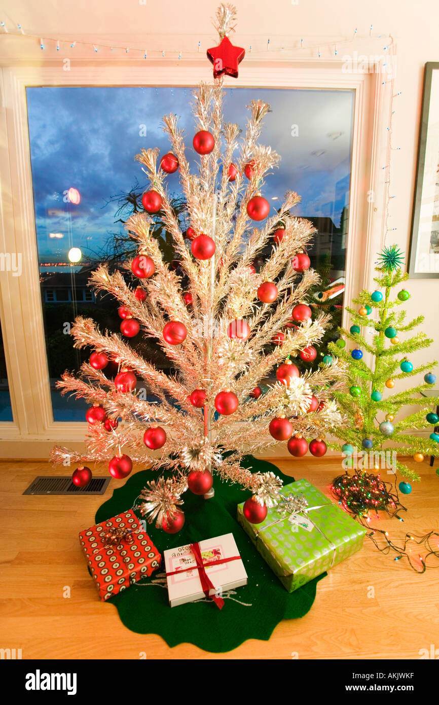 Two fake Christmas trees in living room Stock Photo