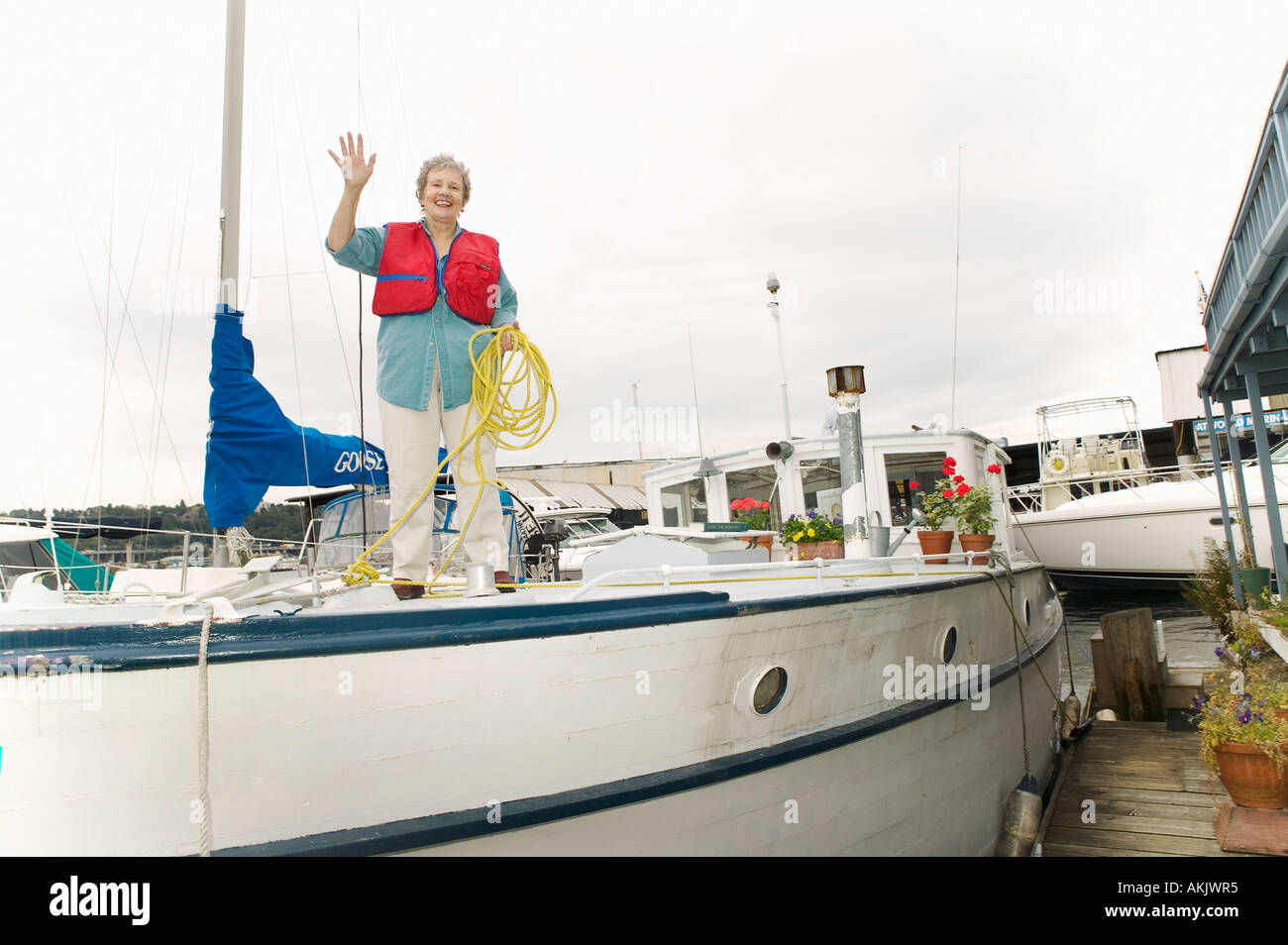 Waving woman on deck of houseboat Stock Photo