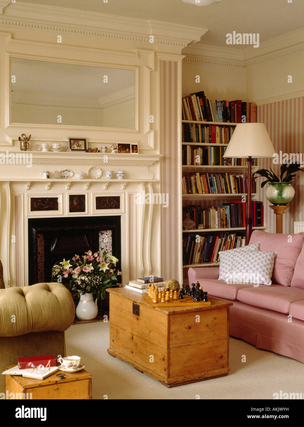Cream overmantel mirror above cream Edwardian fireplace in living room ...