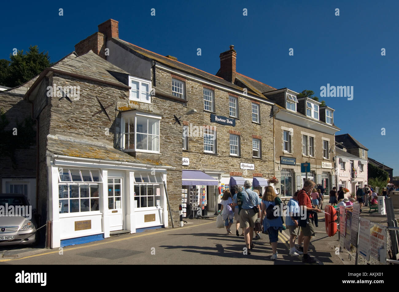 The buildings around the harbour at Padstow are built of warm toned stone evocative of centuries of tradition Stock Photo