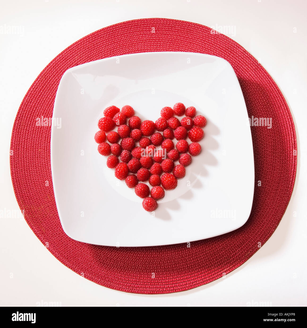 Raspberries arranged in heart shape Stock Photo