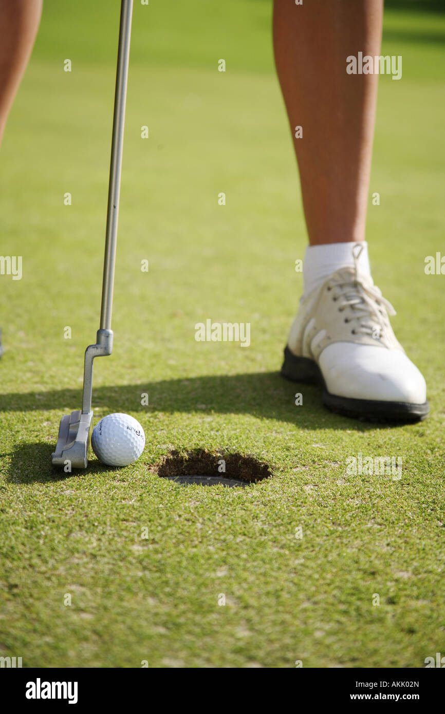 person putting a golf ball Stock Photo