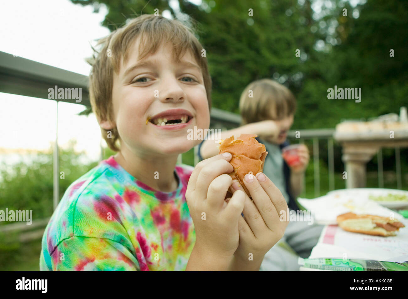 Boy with missing teeth eating lunch Stock Photo