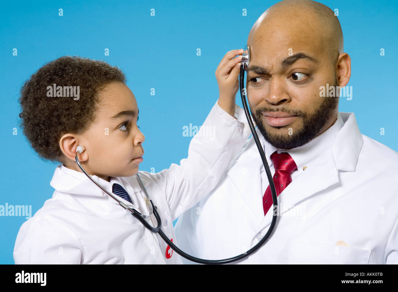 Young boy with stethoscope and male doctor Stock Photo Alamy