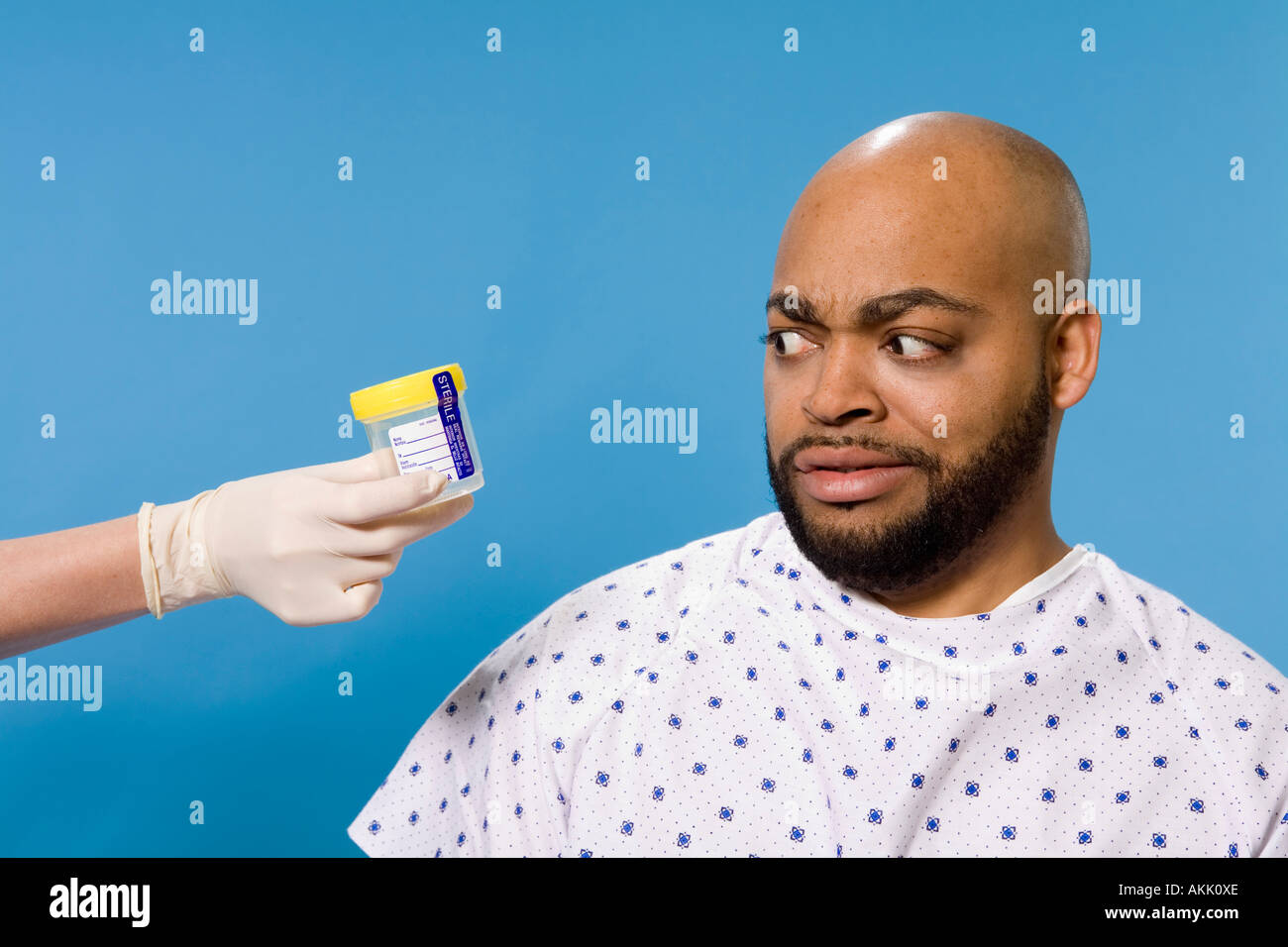 Male patient being handed sample container Stock Photo - Alamy