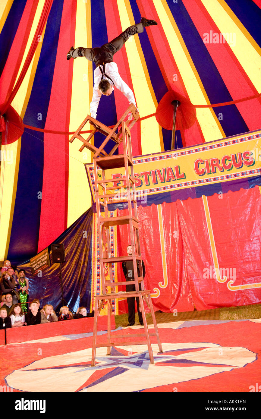 Festival Circus at Wickerman Music Festival dangerous balancing act under the big top tent with chairs Dundrennan Scotland UK Stock Photo