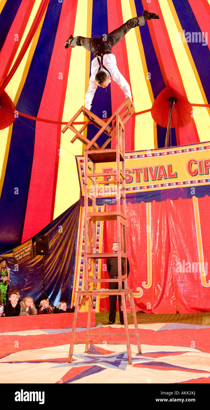 Festival Circus at Wickerman Music Festival dangerous balancing act under the big top tent with chairs Dundrennan Scotland UK Stock Photo
