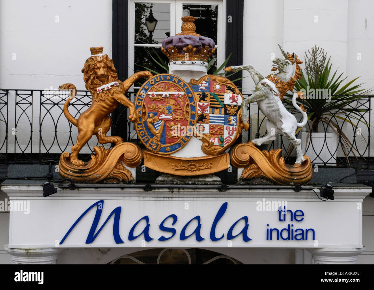 Sign for the Masala Indian Restaurant topped by the most splended Royal Coat of Arms Stock Photo