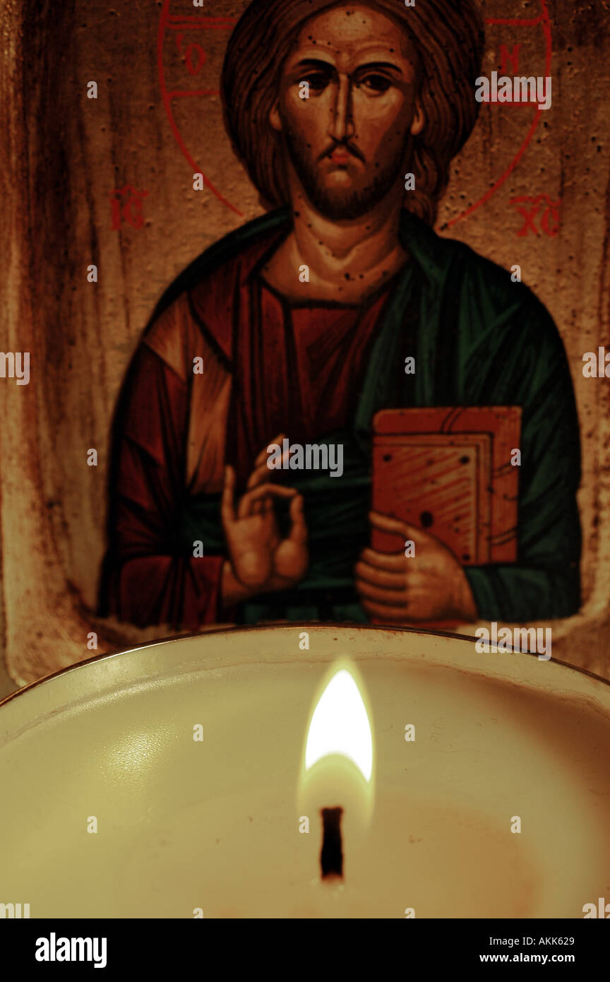 Candle and Icon of a saint  Stock Photo