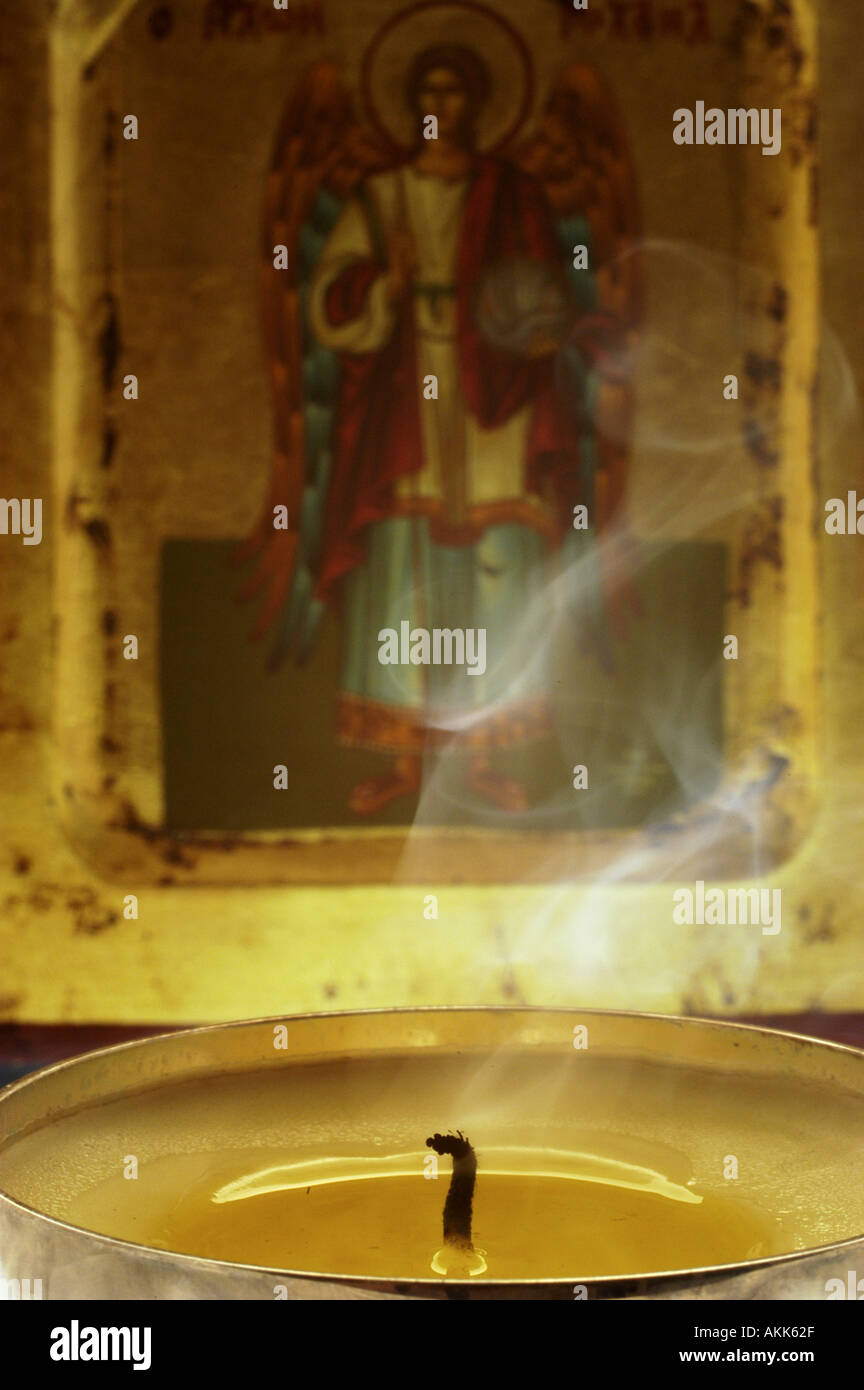 Snuffed out candle in front of an icon Stock Photo Alamy