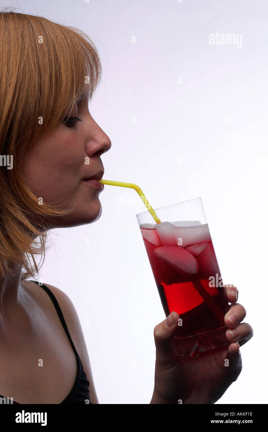 Young Girl drinking Red Grape Juice through a straw profile Keywords