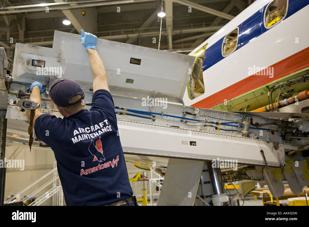 Workers do heavy maintenance on American Eagle Embraer jet airplanes at Sawyer International Airport Stock Photo