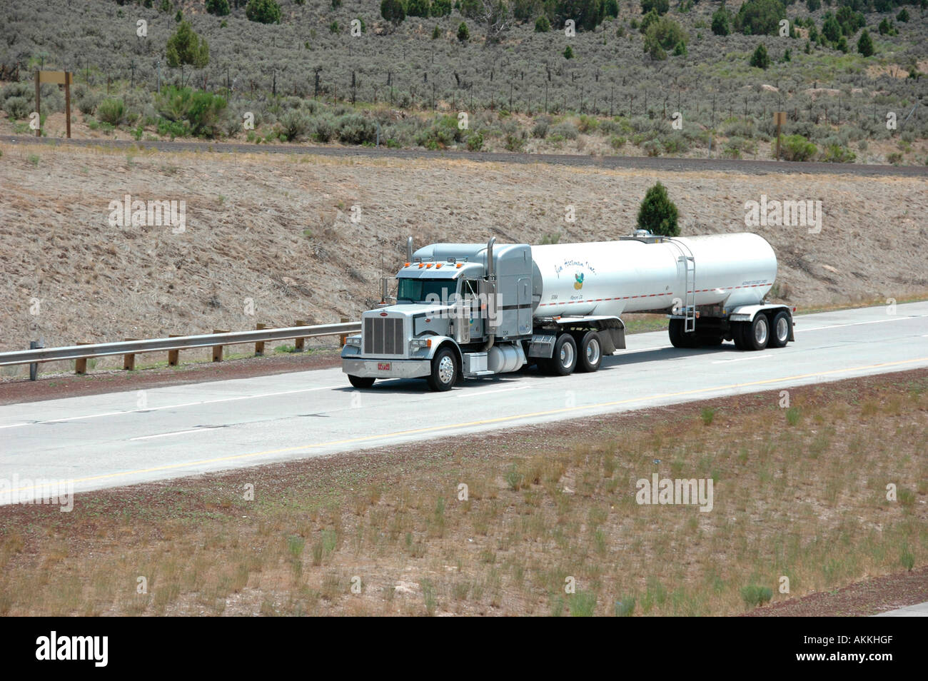Commercial trucks hauling freight on interstate highway in Utah with
