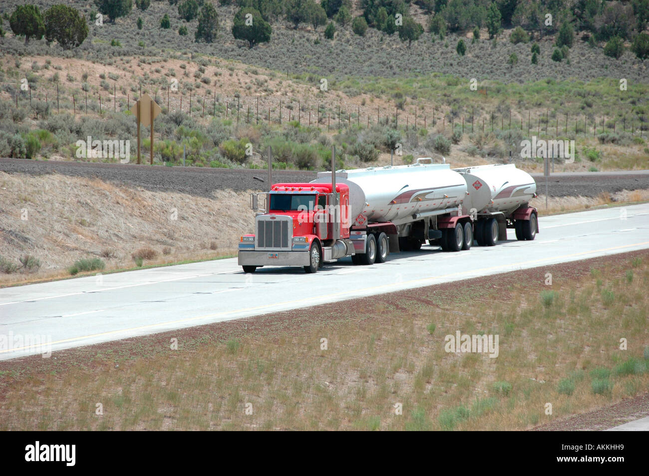 Commercial trucks hauling freight on interstate highway in Utah with