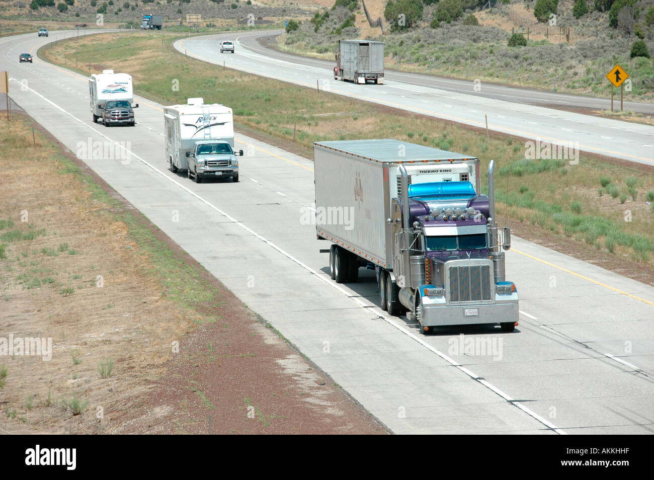 Commercial trucks hauling freight on interstate highway in Utah with