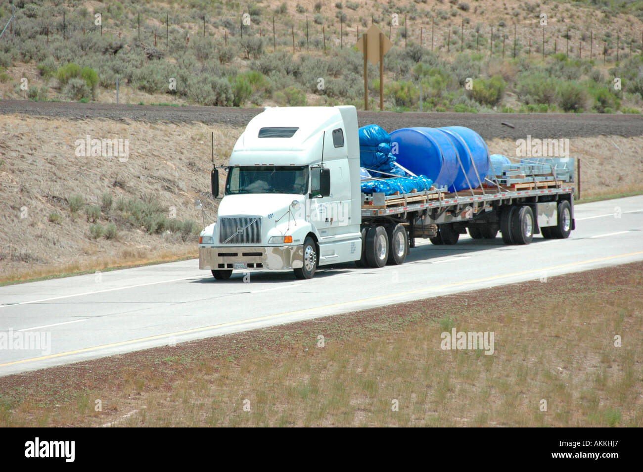 Commercial trucks hauling freight on interstate highway in Utah with