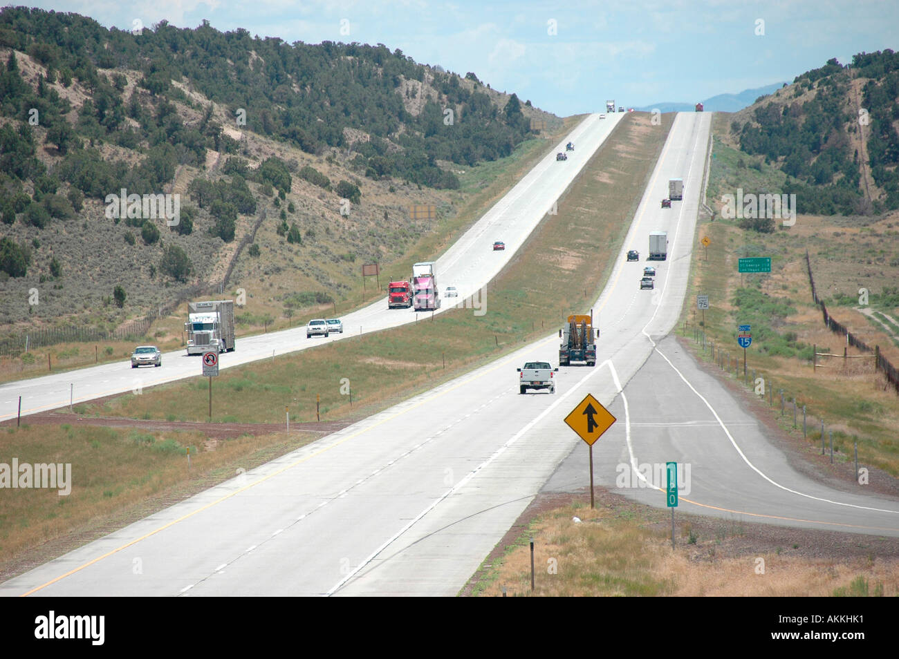 Commercial trucks hauling freight on interstate highway in Utah with