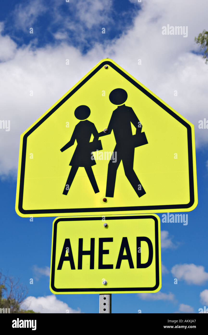 SIGNS Lincolnshire Illinois School crossing ahead sign boy girl walking silhouette bright colorful information sign Stock Photo