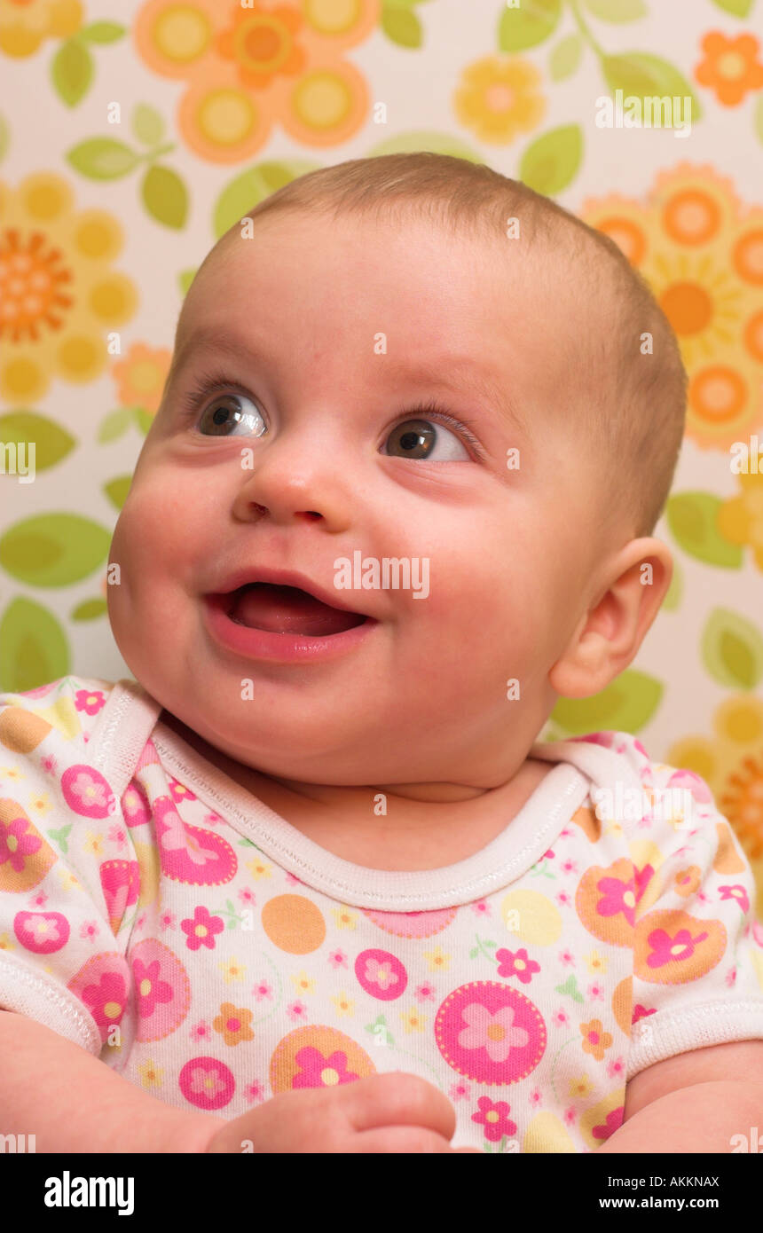 a-happy-six-month-old-baby-posing-in-floral-patterns-stock-photo-alamy