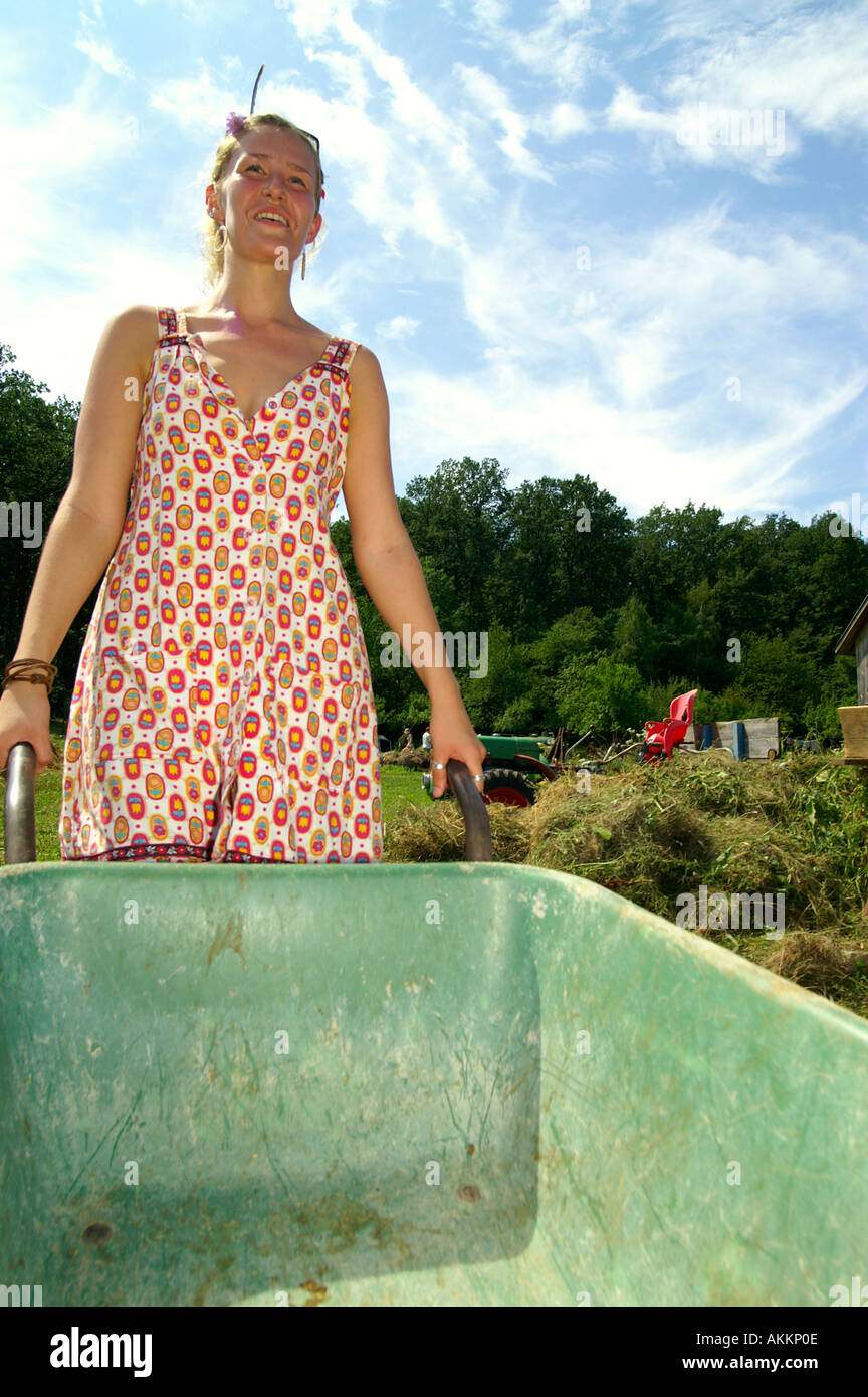 Woman pushing wheelbarrow at organic farm in Slovakia Stock Photo - Alamy