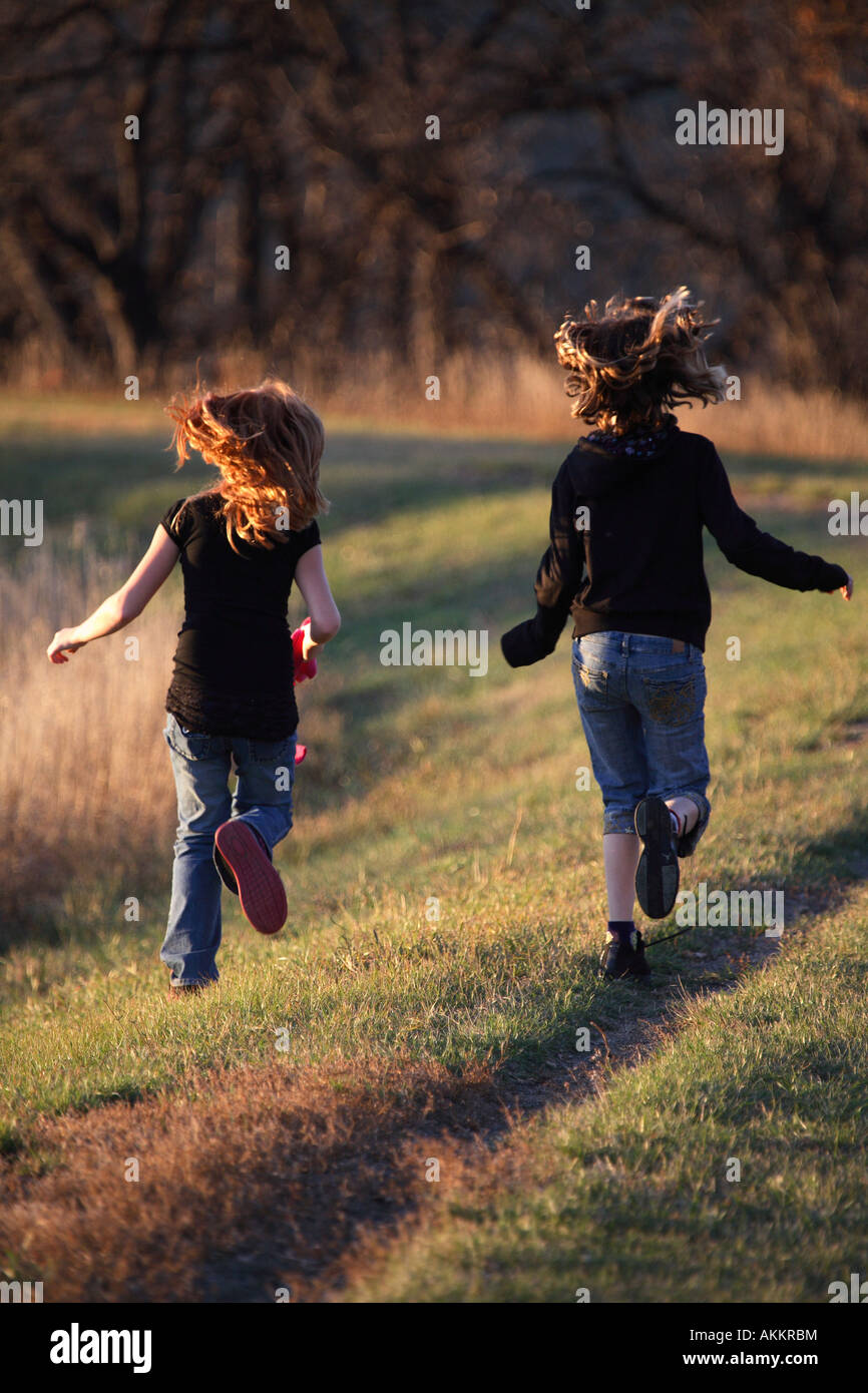 Two girls running along causeway in scenic Saskatchewan Stock Photo Alamy