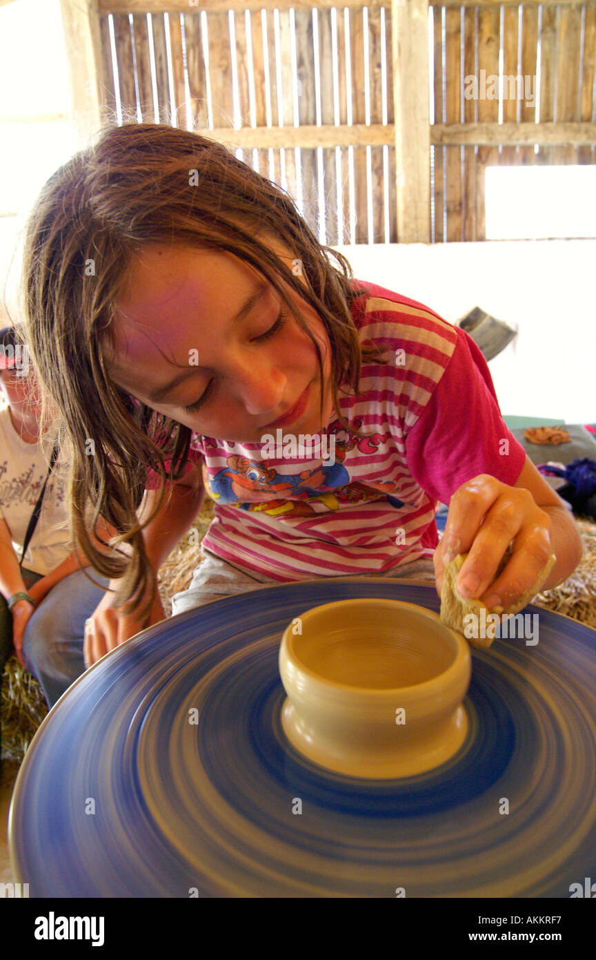 Pottery girl spinning potter's wheel Stock Photo Alamy