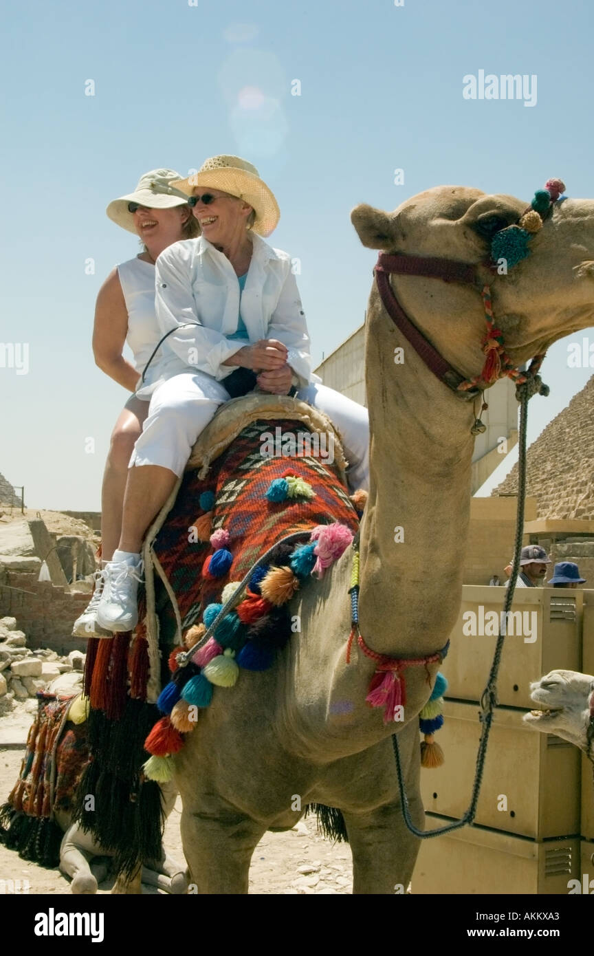 Tourists take camel rides at the Pyramids at Ghiza Cairo Egypt Stock ...