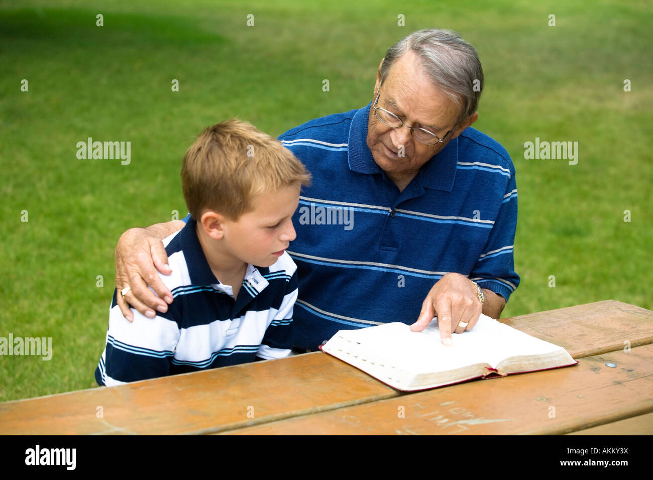 Grandpa and grandson reading the Bible Stock Photo