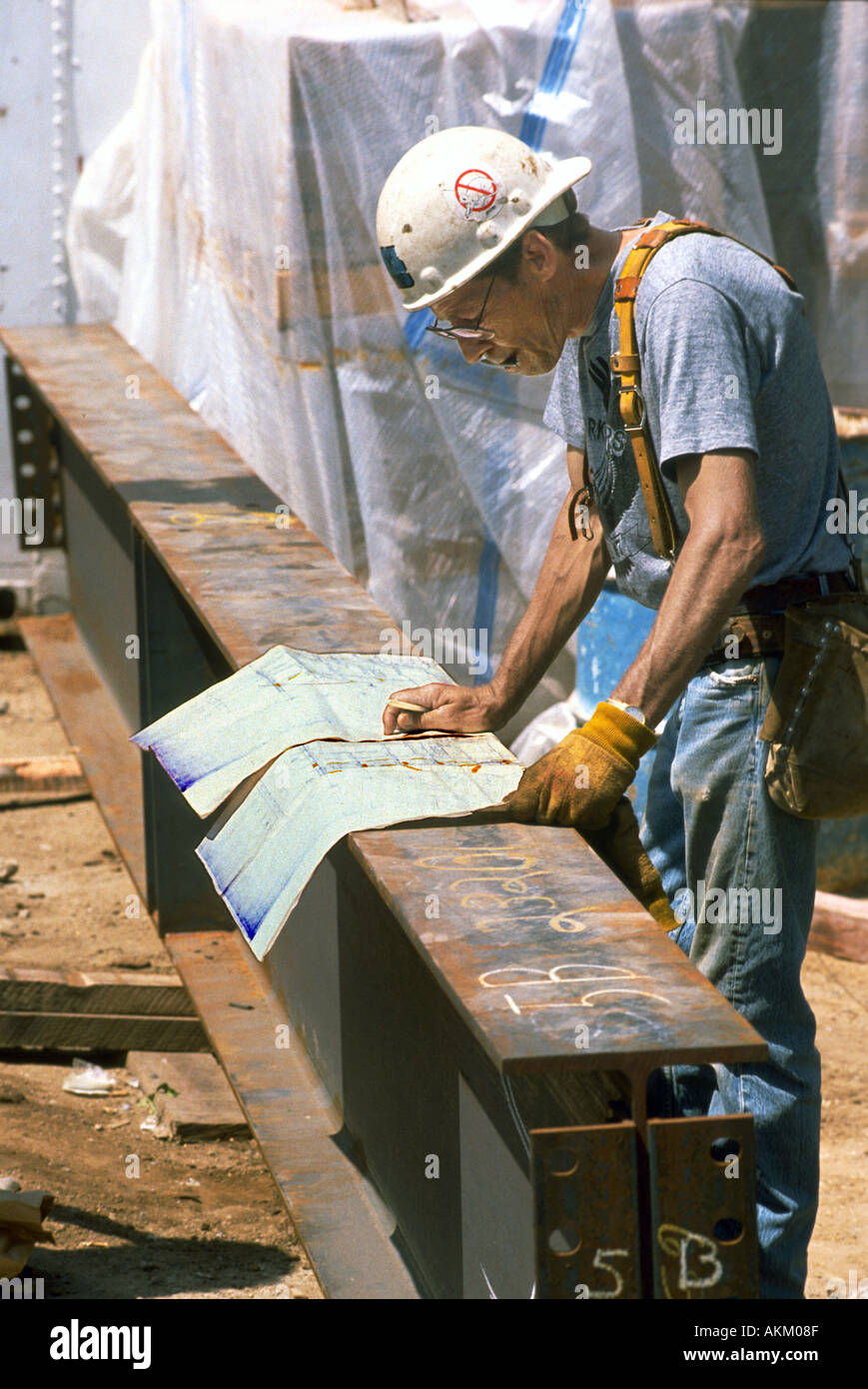 Project manager looks at the blue print plans of a large construction site Stock Photo