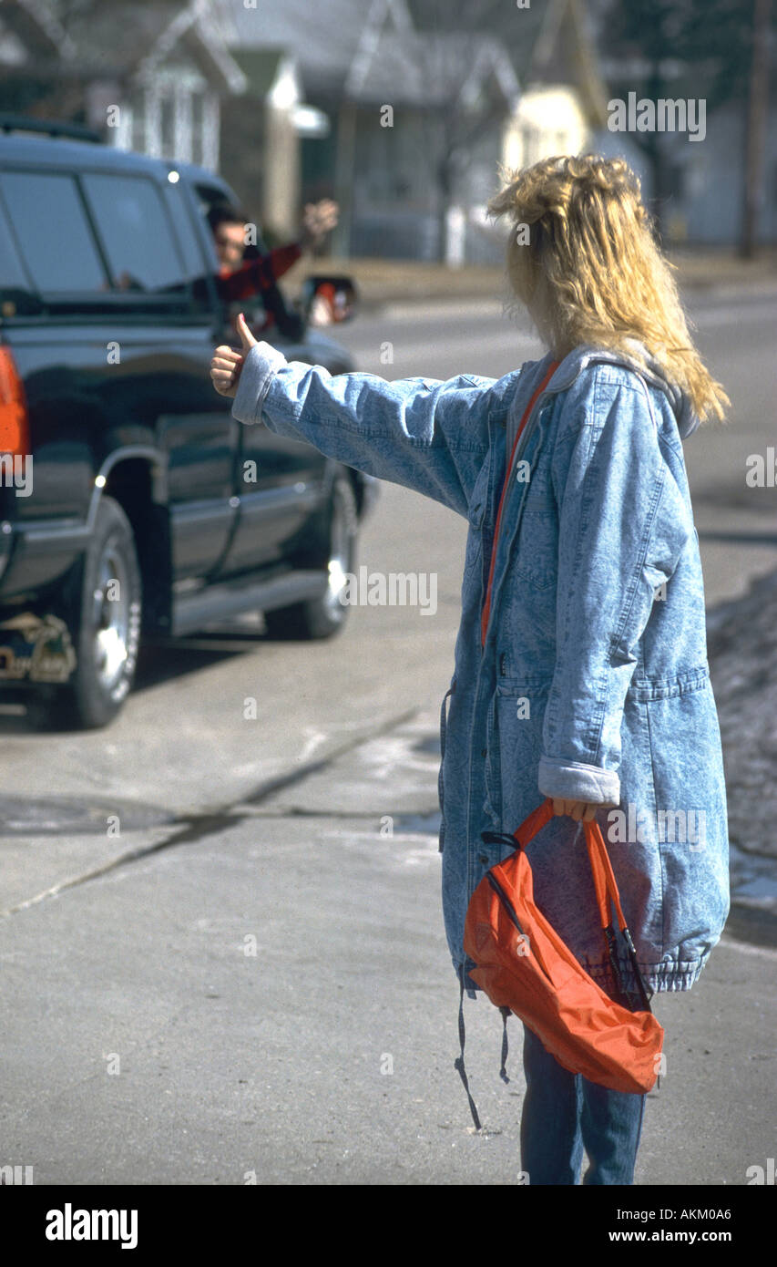 Female hitch hiker has an offer for a ride from a male adult Stock Photo