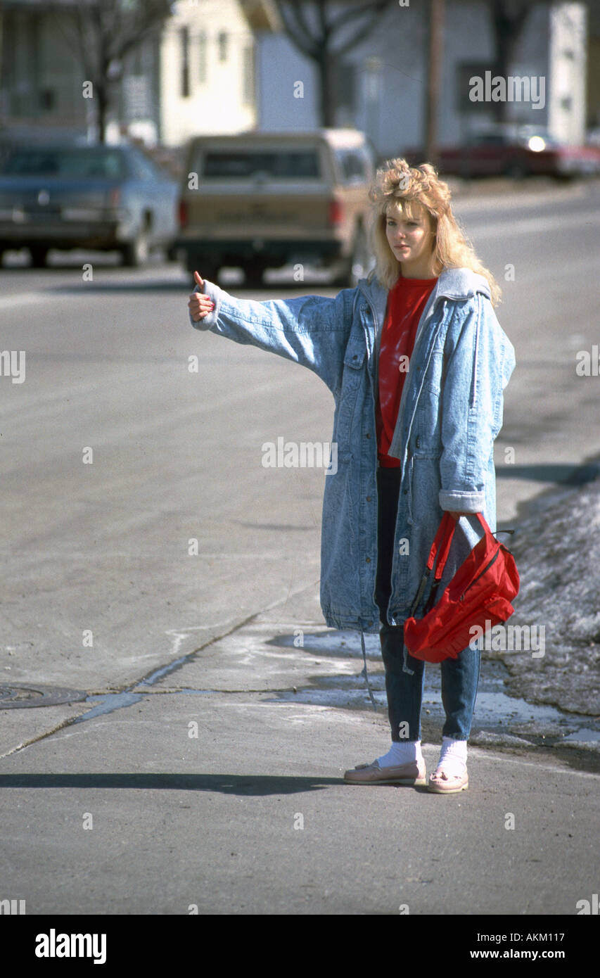 Female hitch hiker has an offer for a ride from a male adult Stock Photo