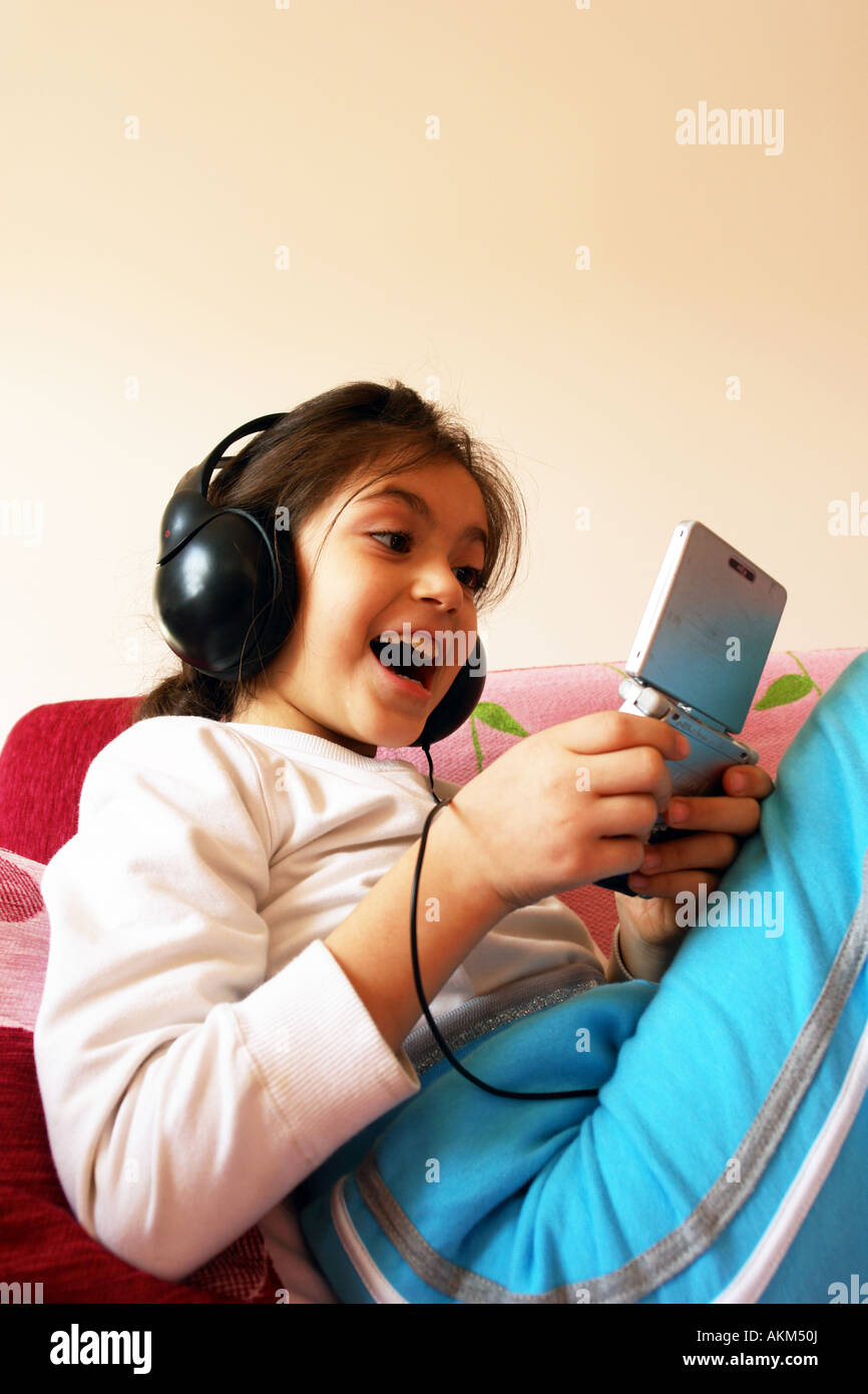 Girl plays gameboy Stock Photo