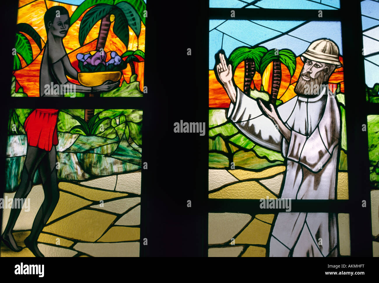 A stained glass window in the St Paul's cathedral in Abidjan Ivory Coast depicts an African man greeting a white missionary Stock Photo