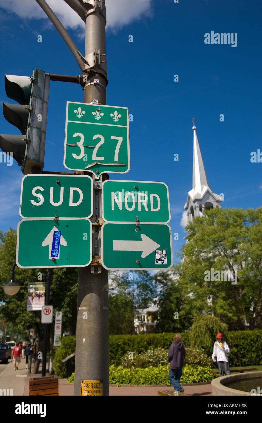 Road signs and church spire St Jovite Mont Tremblant Quebec Canada Stock Photo