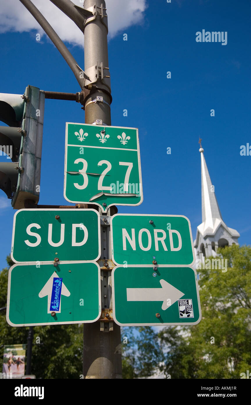 Road signs and church spire St Jovite Mont Tremblant Quebec Canada Stock Photo