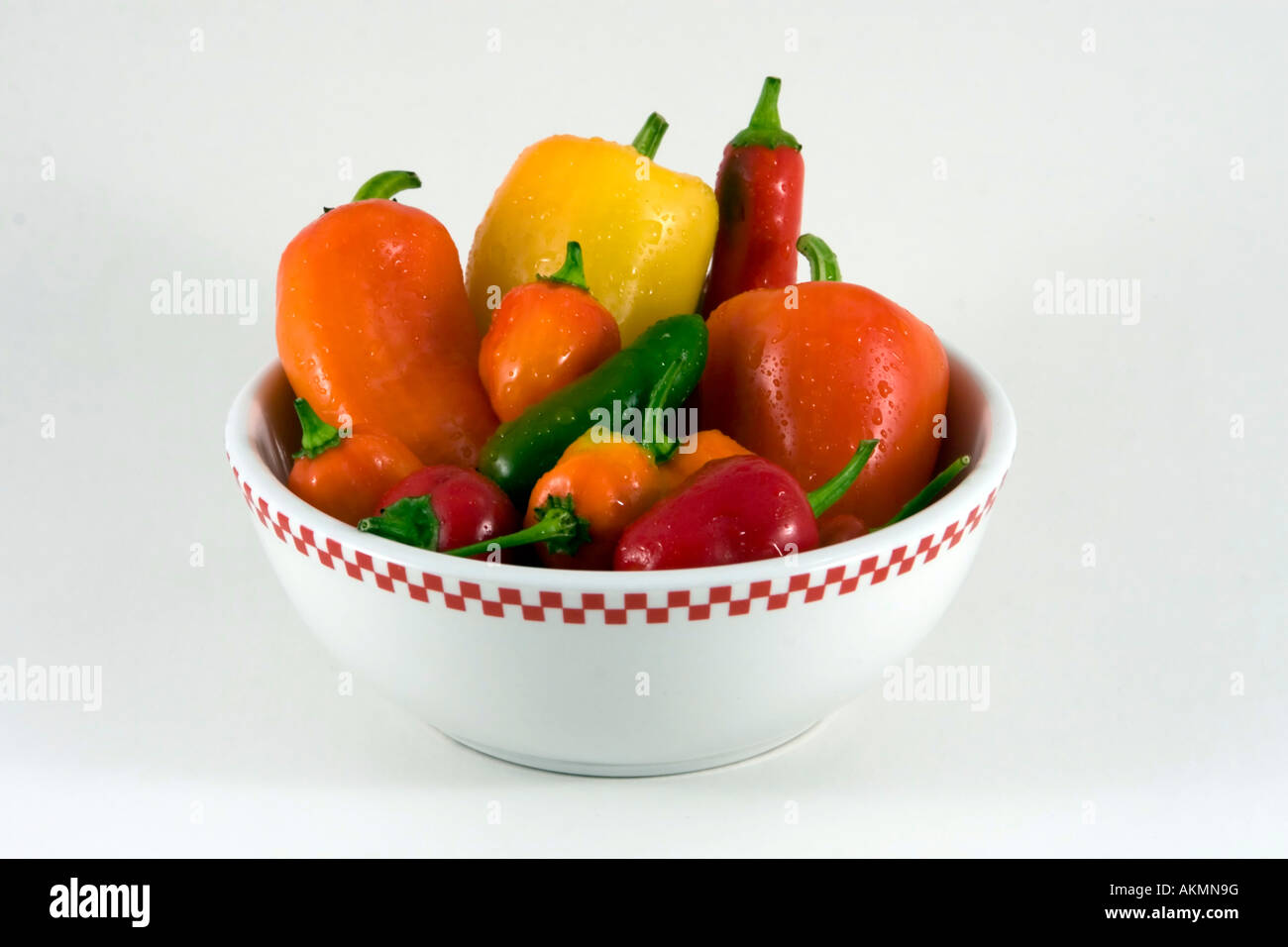 Assorted peppers in a white bowl Stock Photo
