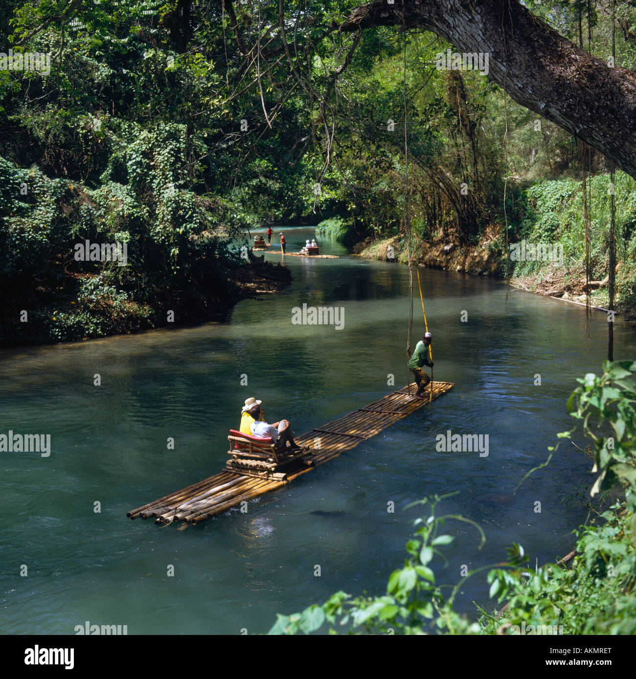 Couple on the Martha Brae river rafting trip with overhanging tree ...